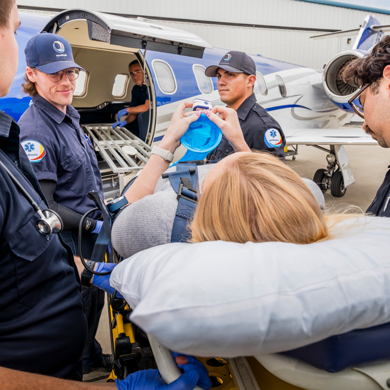 Paramedics assist patient boarding