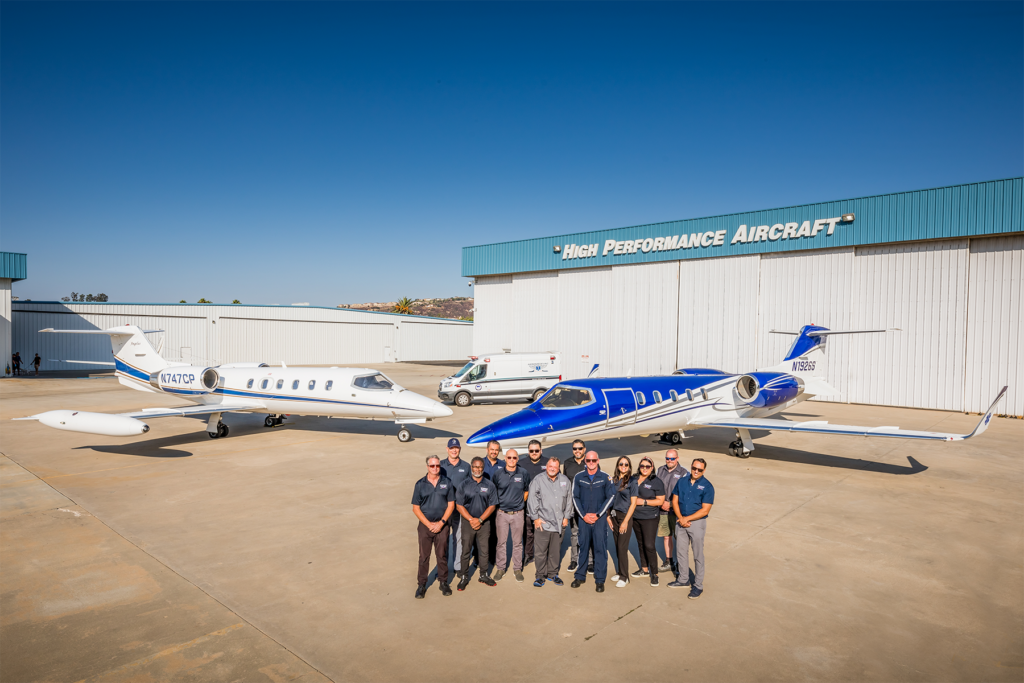 Team posing with jets